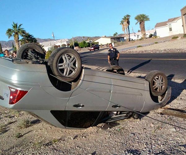 overturned car on the side of the road